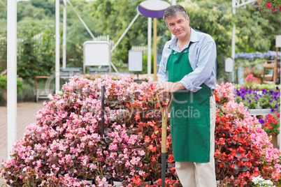 Cheerful man holding a spade