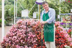 Cheerful man holding a spade