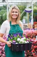 Cheerful florist carrying boxes