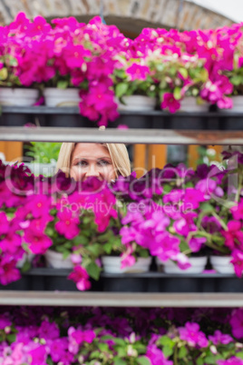 Woman looking through shelves in flowers store