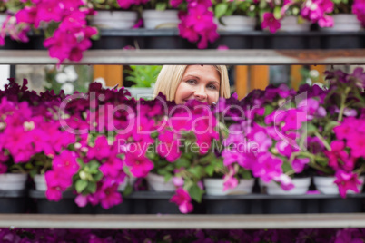 Woman smiling through shelves