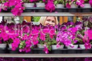 Woman smiling through shelves