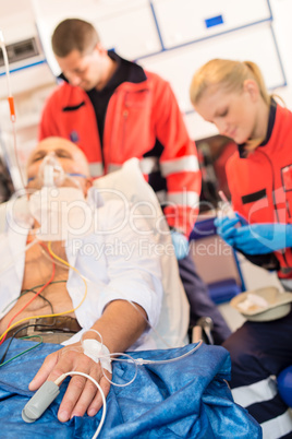 Sick patient with paramedic in ambulance treatment