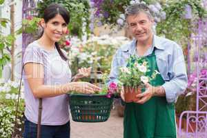 Happy customer with garden center worker