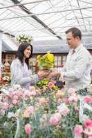 Happy couple holding up yellow flower