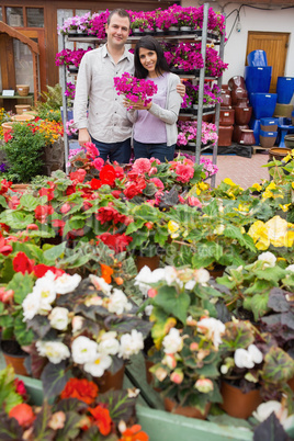 Couple standing with purple flowers