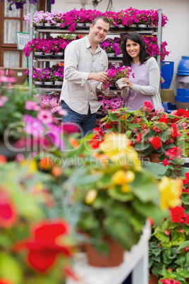 Happy couple holding purple flowers