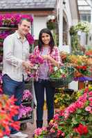 Couple holding bouquet and basket