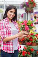 Smiling woman holding a flower