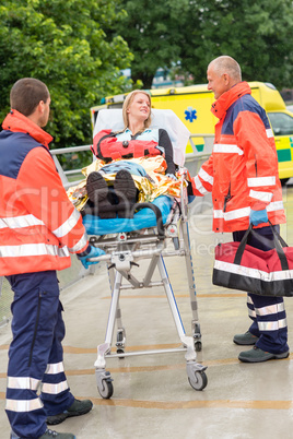 Injured woman talking with paramedics emergency