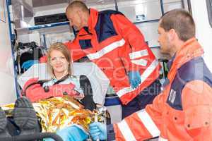 Woman with broken arm in ambulance paramedics