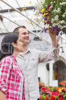 Couple admiring hanging flower basket