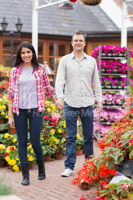 Couple holding hands in garden center