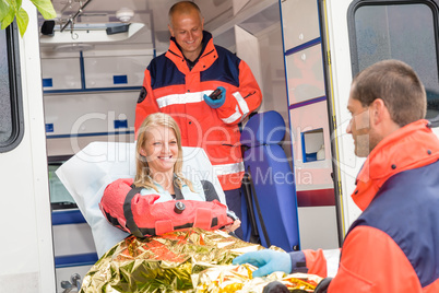 Woman with broken arm in ambulance paramedics