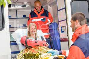 Woman with broken arm in ambulance paramedics