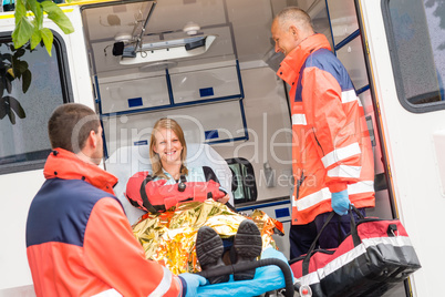 Emergency doctor with woman in ambulance