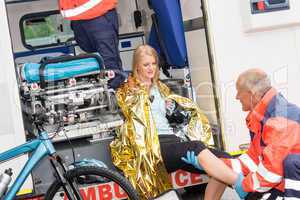 Paramedics with woman bike accident in ambulance