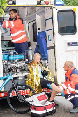 Paramedics with woman bike accident in ambulance