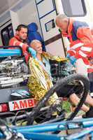 Emergency paramedics helping woman bike accident