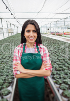 Greenhouse worker smiling in greenhouse nursery