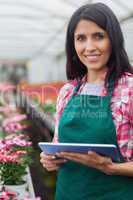 Woman doing inventory in greenhouse