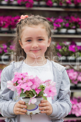 Little girl holding a plant