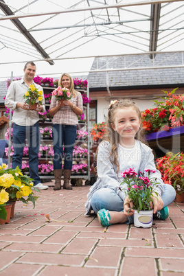 Happy family holding flower pots