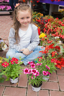 Little girl with flowers around her