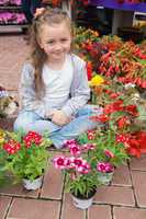 Little girl with flowers around her