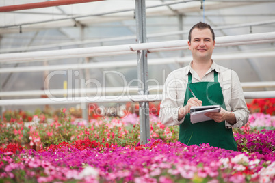 Smiling man taking notes