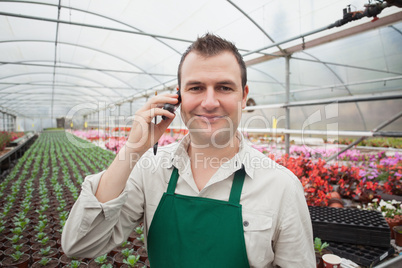 Employee on the phone in greenhouse