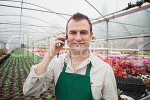 Employee on the phone in greenhouse