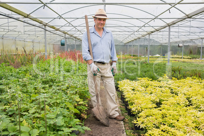 Man holding a spade while smiling