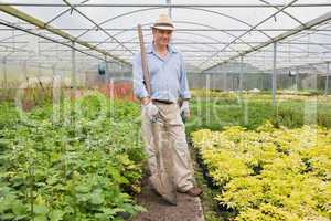 Man holding a spade while smiling