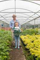 Gardener and little girl holding a watering can