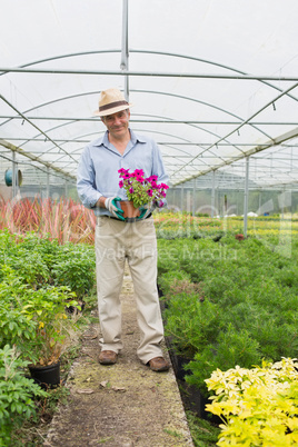 Smiling man holding a flower