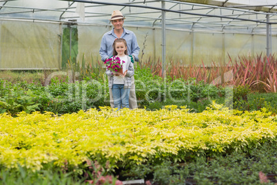 Gardener with grandchild holding purple flower