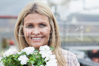 Smiling blonde holding white flowers