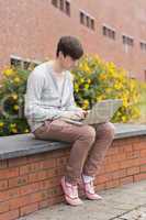 Student using laptop outside