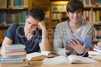 Young man with tablet pc in the library Young man with tablet pc in the library