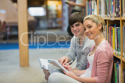 People sitting in front of a bookshelf