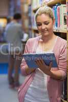 Woman using tablet pc in college library
