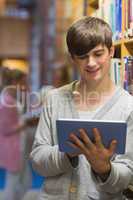 Man using tablet pc in college library