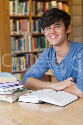 Student sitting at desk while smiling