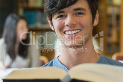 Man sitting at the library reading a book