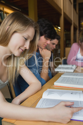 Students studying around library table