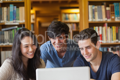 Students sitting looking at a laptop