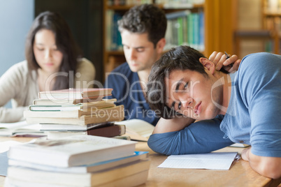 Tired student resting in library