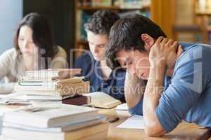 Student falling asleep in library