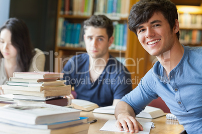 Student leaning at the table smiling